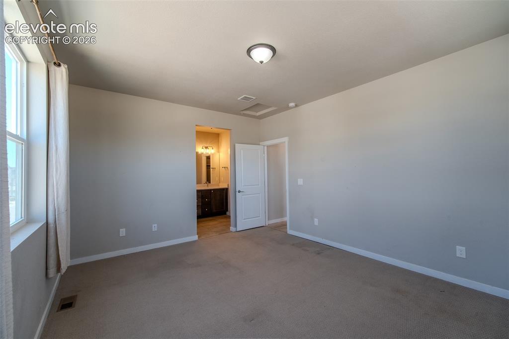 Image 31 of 46: Spacious Upper Level Primary Bedroom with adjoining Shower Bathroom.