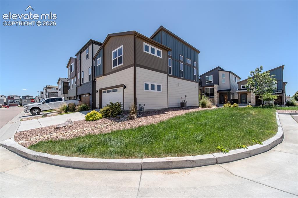 Image 40 of 46: Side and rear view of home with 2-car attached garage.