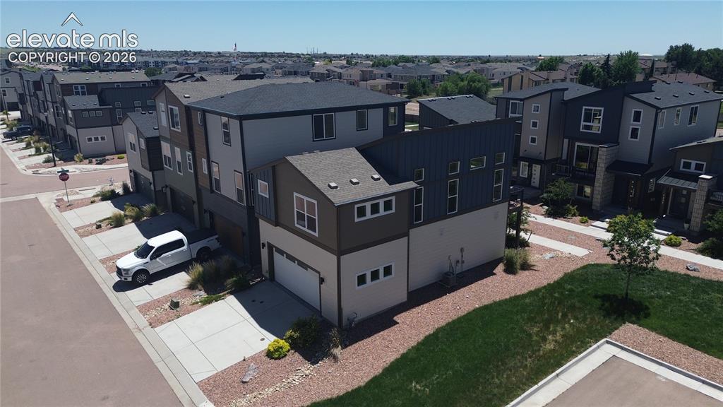 Image 43 of 46: Aerial rear and side view of home and xeriscaped lot.