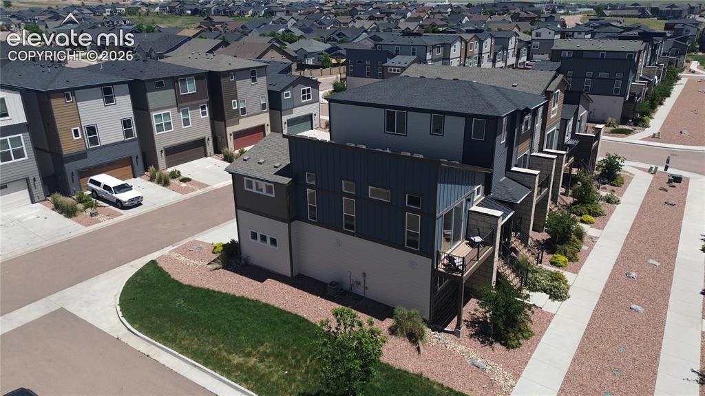 Image 5 of 46: Aerial view of front and side xeriscaped lot.