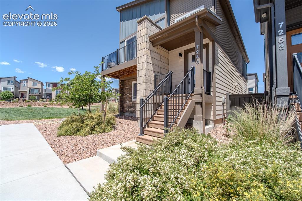 Image 7 of 46: Stairs to the covered front porch.