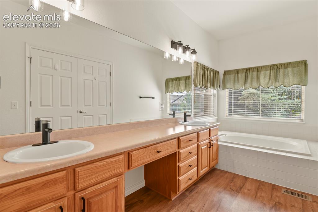 Image 24 of 50: Primary Bath with new lighting and hardware! Double Sinks, Soaking tub and
