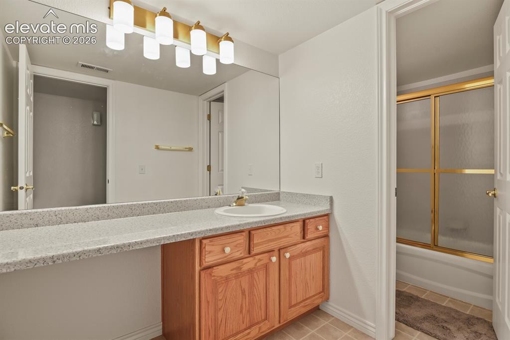 Image 32 of 50: Lower full bath with NEW lighting!