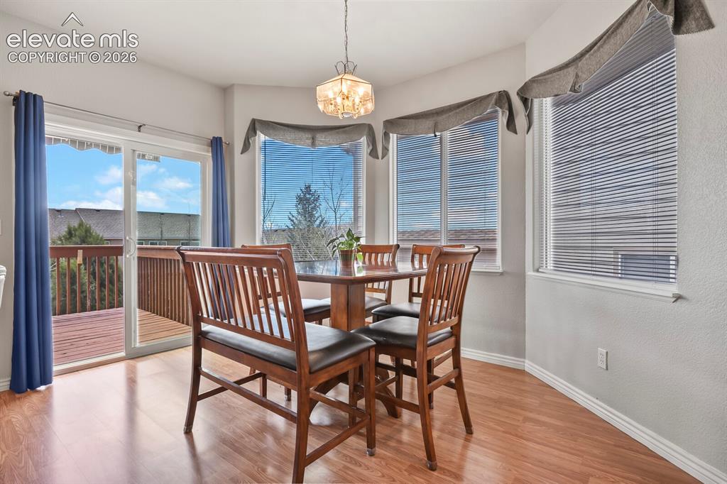 Image 7 of 45: Lovely dining area with walk out to deck with views