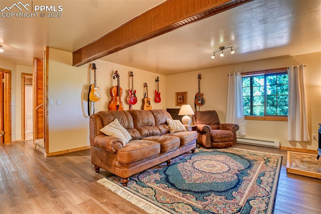 Image 23 of 38: Family room with newer LVP flooring