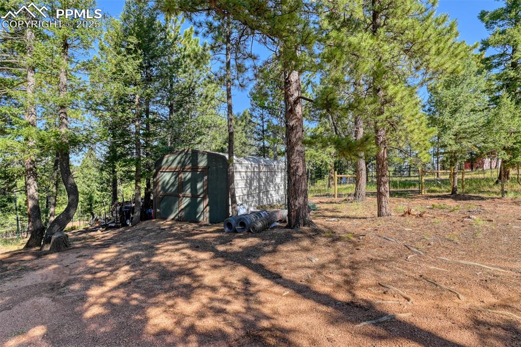 Image 35 of 38: Enclosed carport/outbuilding