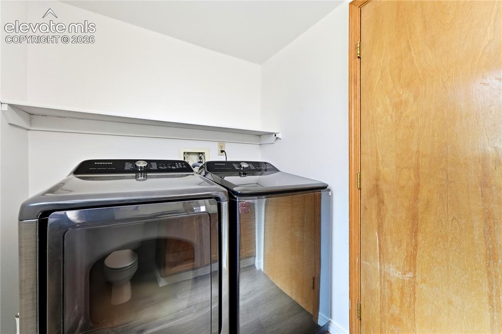 Image 14 of 47: Laundry area on the main level in the half bath with shelf