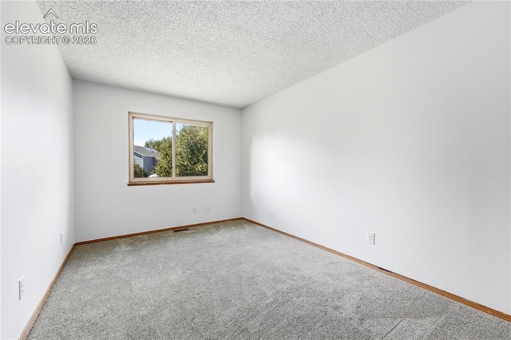 Image 21 of 47: Neutral wall finish, carpeted flooring, faux wood vinyl window