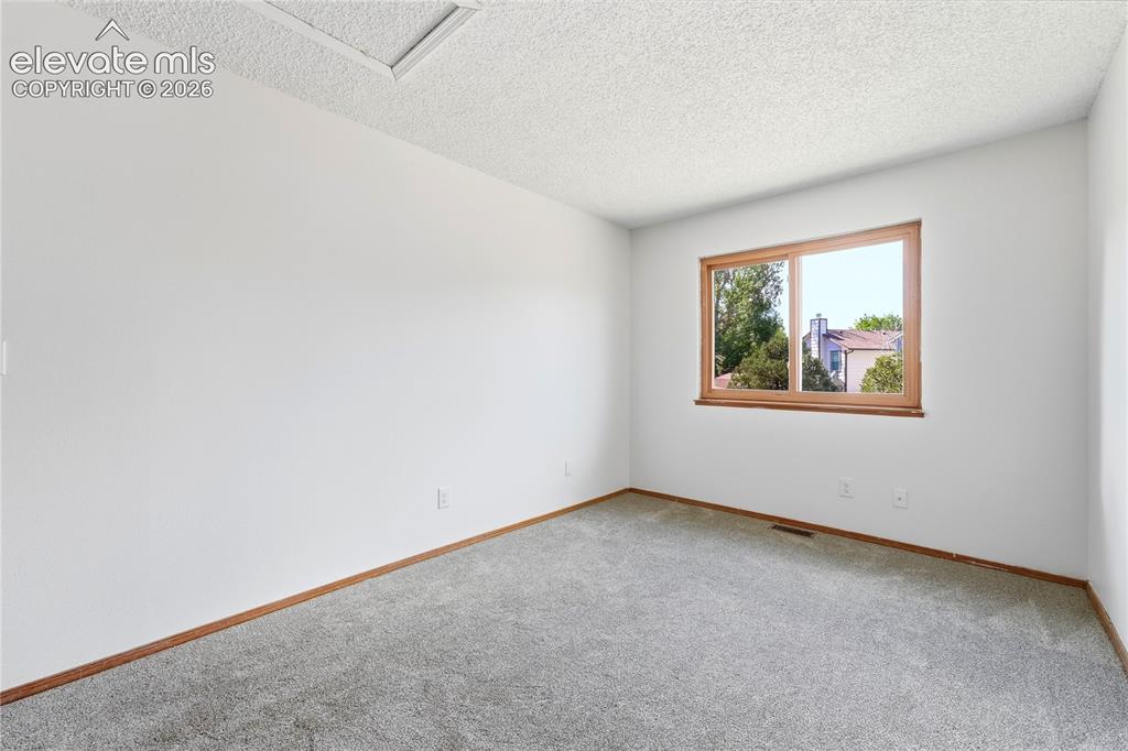 Image 22 of 47: Neutral wall finish, carpeted flooring, faux wood vinyl window