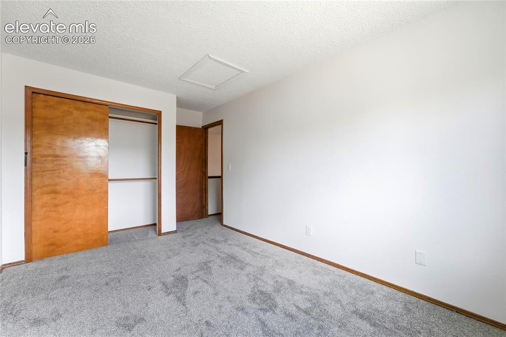 Image 23 of 47: Neutral wall finish, carpeted flooring, faux wood vinyl window