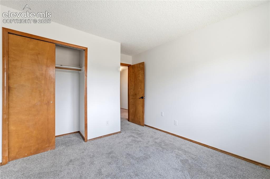 Image 27 of 47: Light gray carpet, white walls
