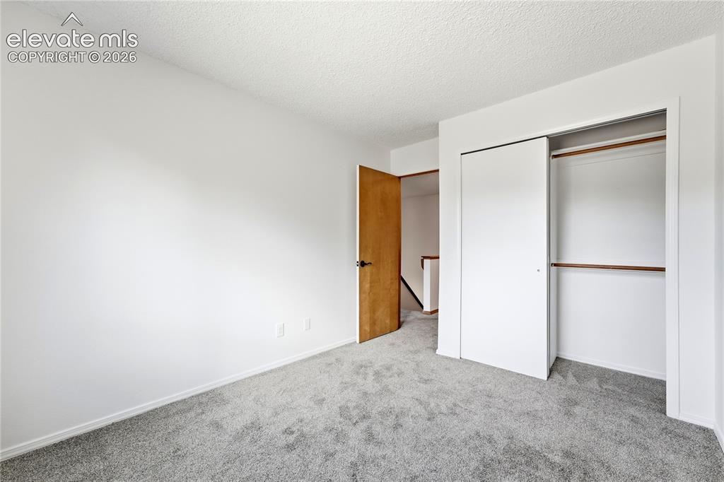 Image 30 of 47: Light gray carpet, white walls