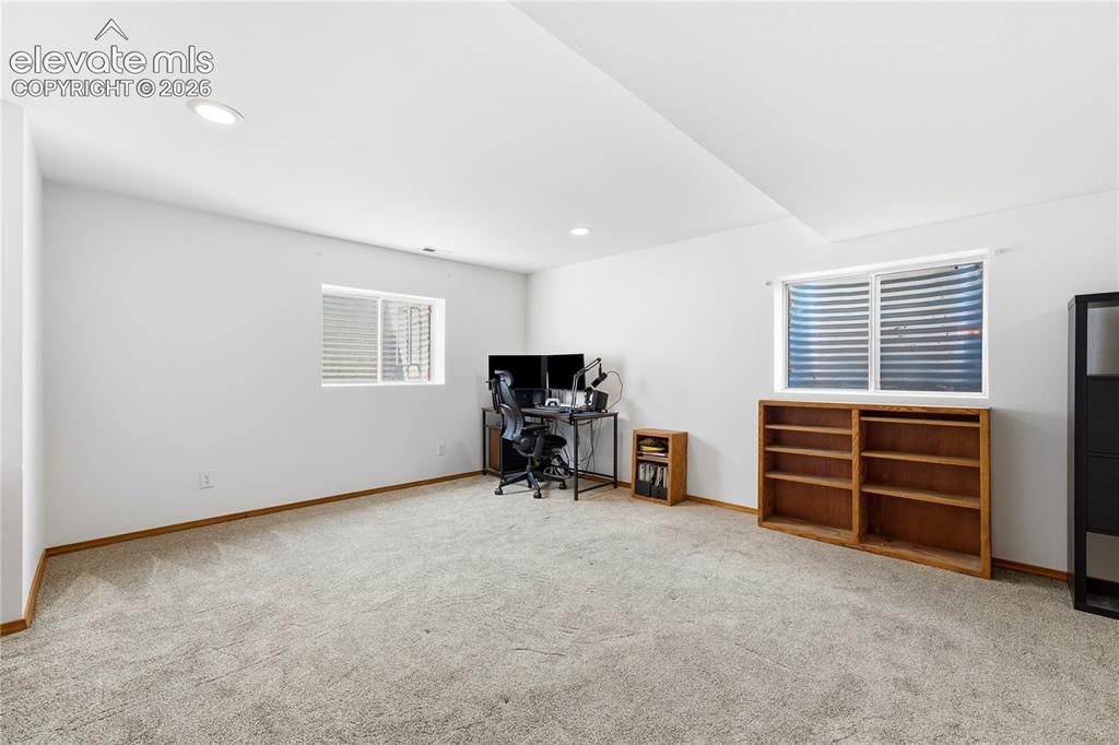 Image 33 of 47: Spacious room featuring light-colored carpeting, white walls, recessed ligh