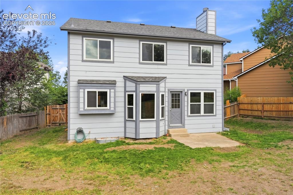 Image 40 of 47: Two-story exterior with horizontal siding, multiple windows, a bay window f