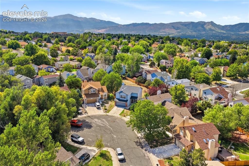 Image 43 of 47: Aerial perspective of a cul-de-sac with mountain range behind