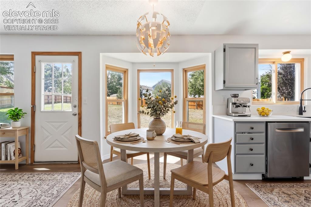 Image 5 of 47: Breakfast nook area with new LVP flooring, virtually staged.