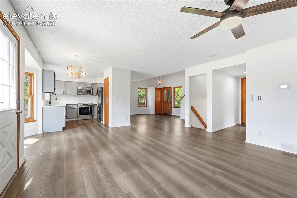 Image 7 of 47: Dining area with new LVP flooring, and additional living room or family roo