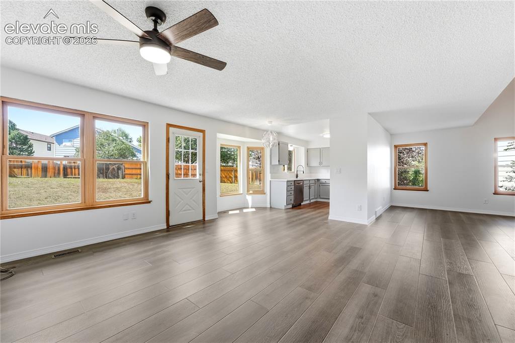 Image 8 of 47: Dining area with new LVP flooring, and additional living room or family roo