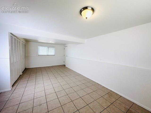Image 12 of 20: Family room with tiled flooring