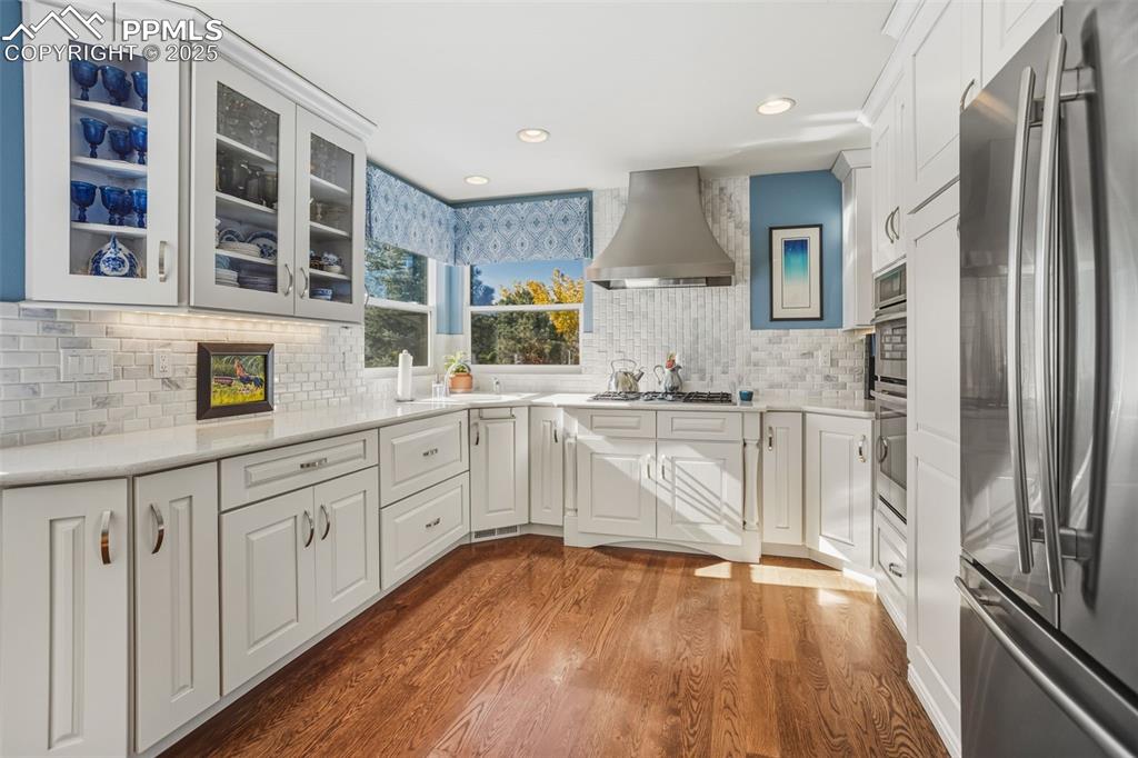 Image 16 of 43: Kitchen with appliances with stainless steel finishes, dark wood finished f