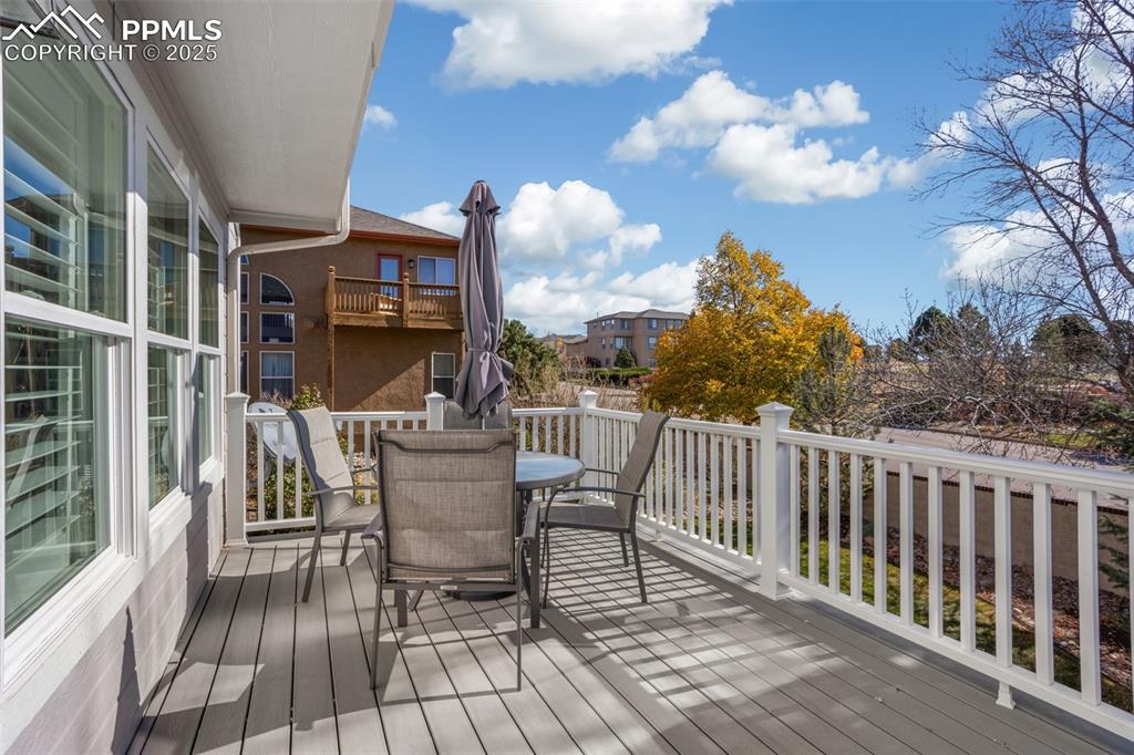 Image 40 of 43: Wooden terrace with outdoor dining area