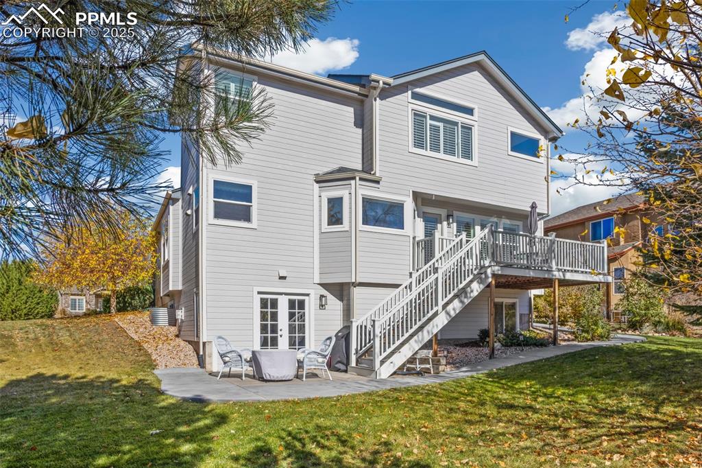 Image 43 of 43: Rear view of property with a patio area, a lawn, stairway, and a deck
