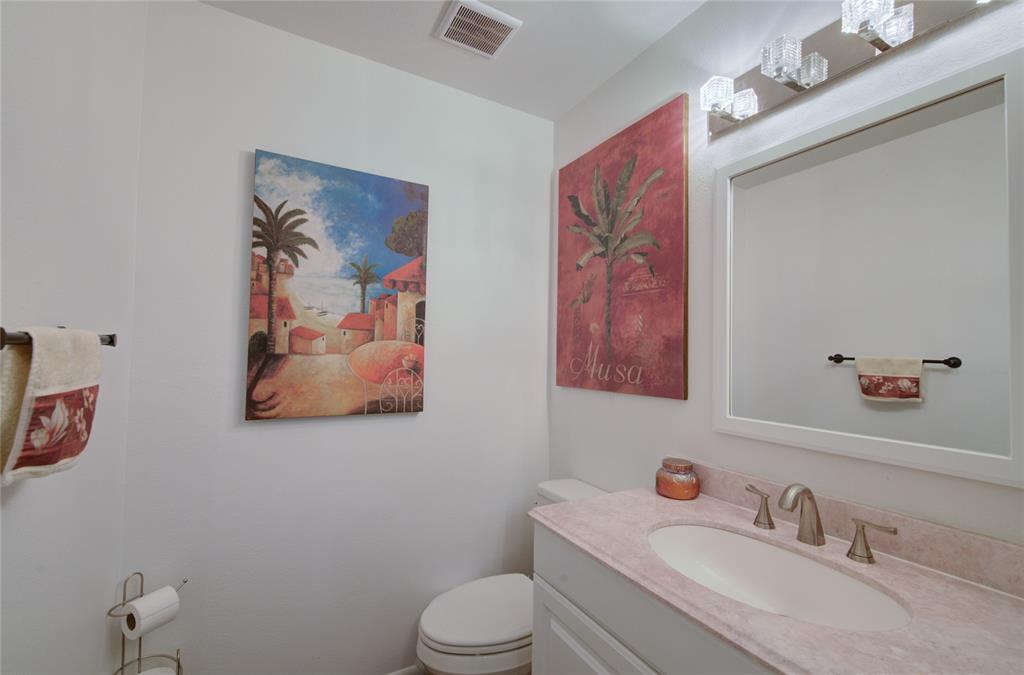 Image 10 of 21: Bathroom vanity featuring a light-toned countertop, undermount sink, and br