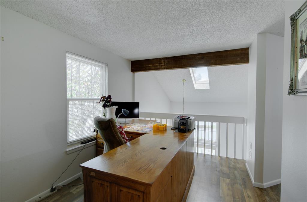 Image 12 of 21: Loft area featuring wood-finish flooring, a window with blinds, and white w