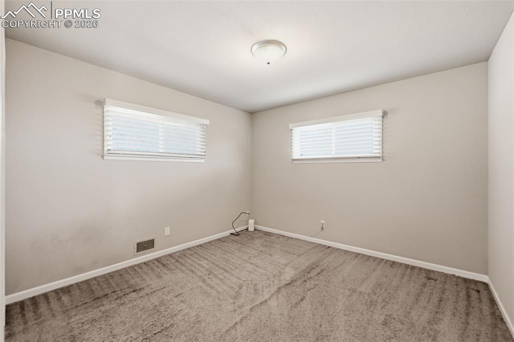 Image 11 of 24: Large bedroom with large, high windows to accommodate all furniture