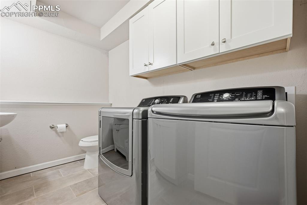 Image 18 of 24: Laundry and 1/2 bath combo with storage!