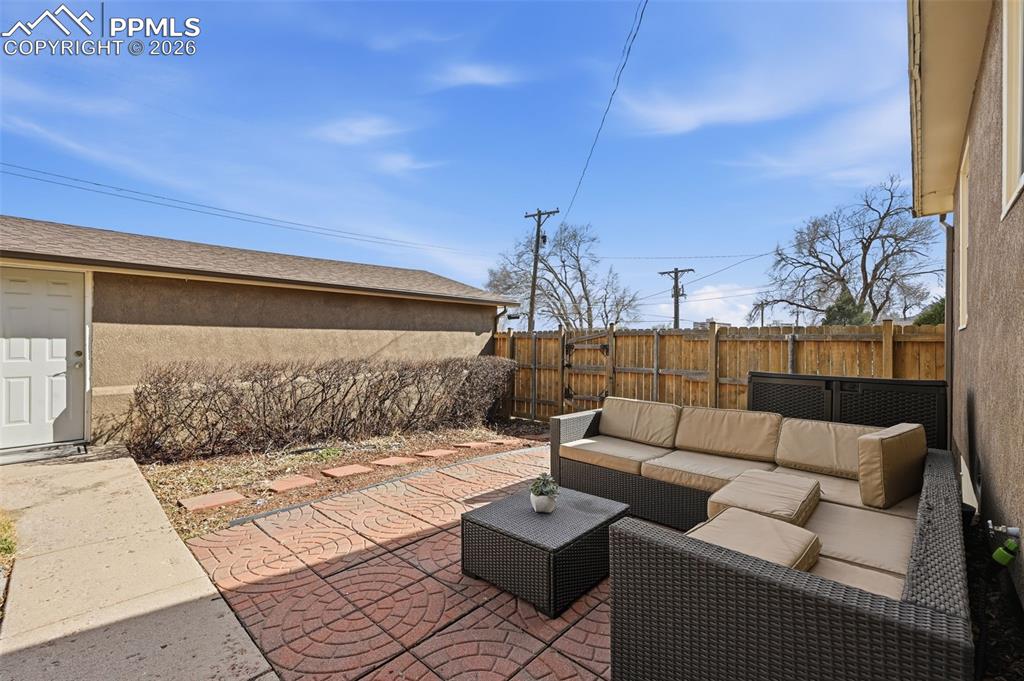 Image 22 of 24: Full fenced in back yard with patio and access to garage