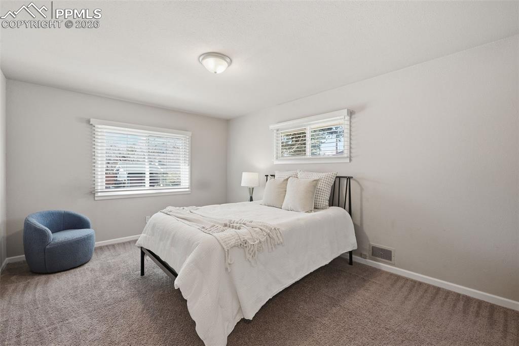 Image 9 of 24: Spacious bedroom with lots of natural night