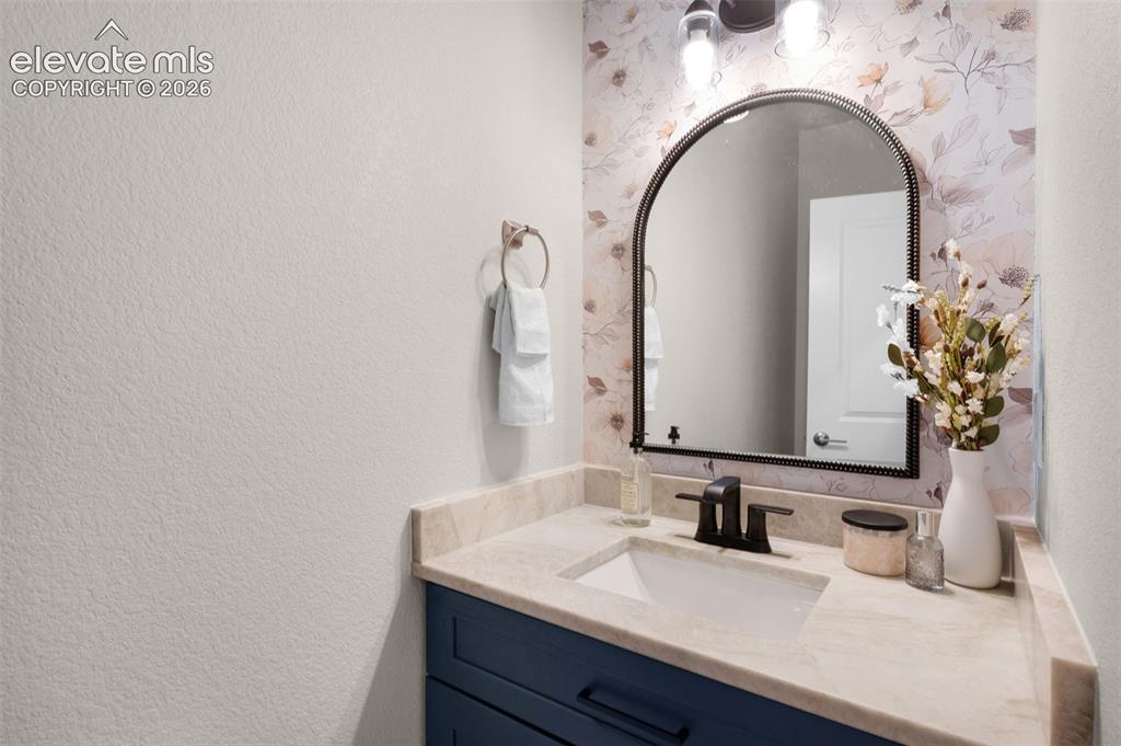 Image 16 of 36: Arched mirror with dark bronze trim