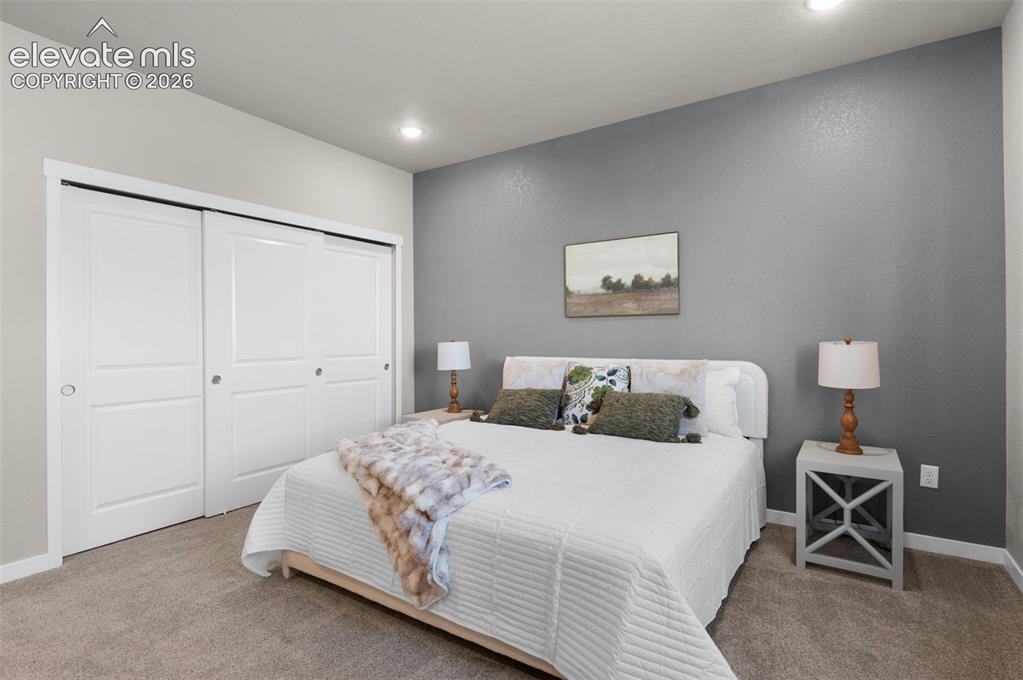 Image 18 of 36: Recessed ceiling lighting, textured accent wall, light-colored walls, white