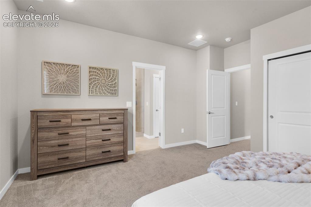 Image 19 of 36: Recessed lighting, light gray wall paint, white trim, and light-colored car