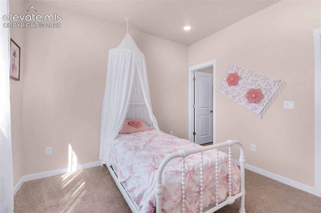 Image 26 of 36: Recessed ceiling lighting, textured wall finish, and carpeted flooring