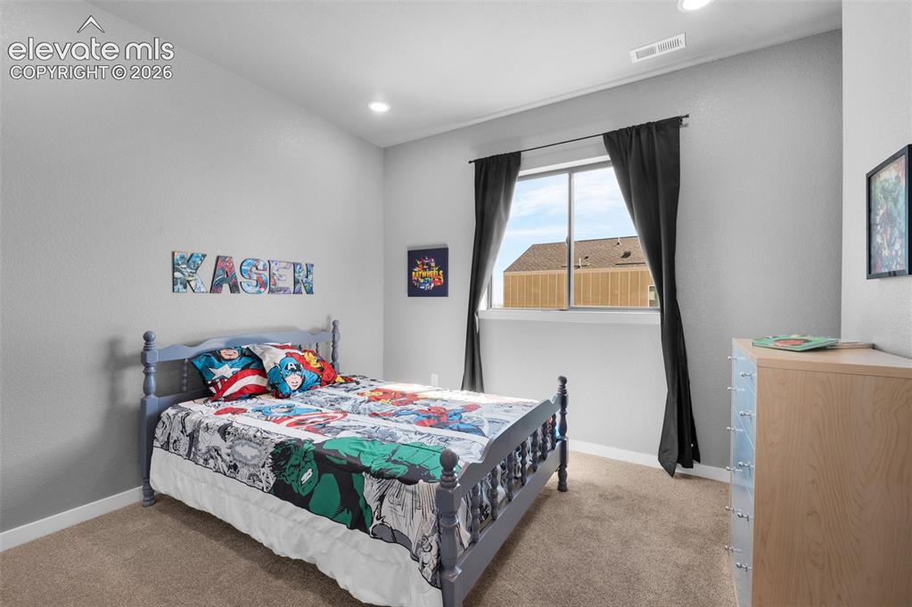 Image 27 of 36: Carpeted flooring, recessed lighting, and a large window with white trim
