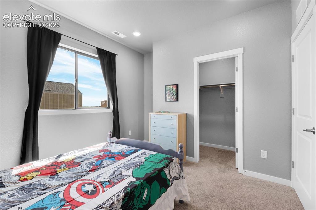Image 28 of 36: Window with natural light, wall-to-wall carpeting, overhead recessed lighti