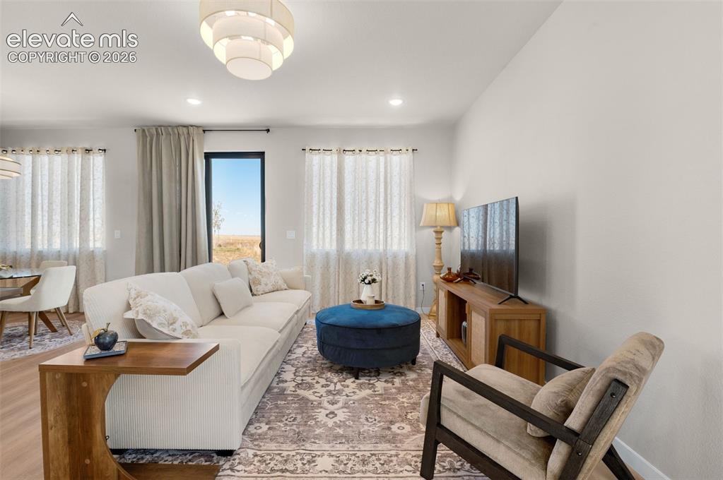 Image 3 of 36: Recessed ceiling lighting, wood-finish flooring, and a contemporary ceiling