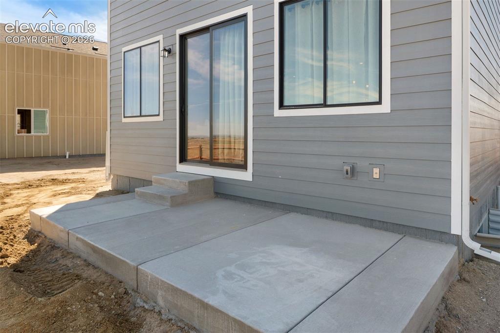 Image 31 of 36: Concrete patio with stepped entry