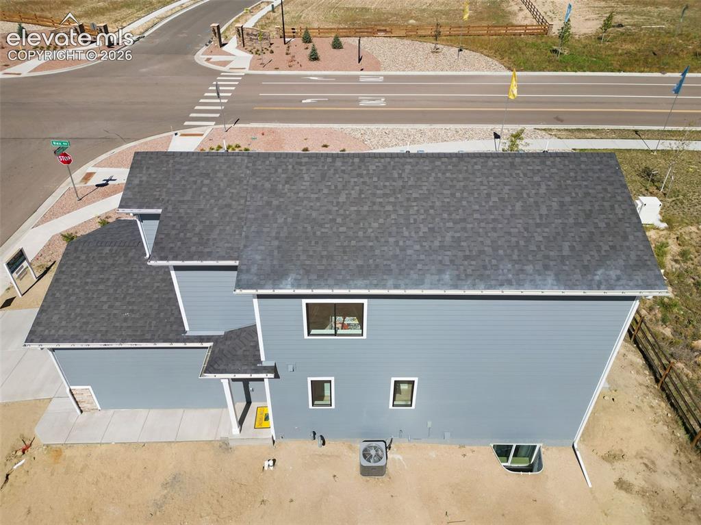 Image 35 of 36: Two-story property with gray shingle roofing, blue horizontal siding, and w
