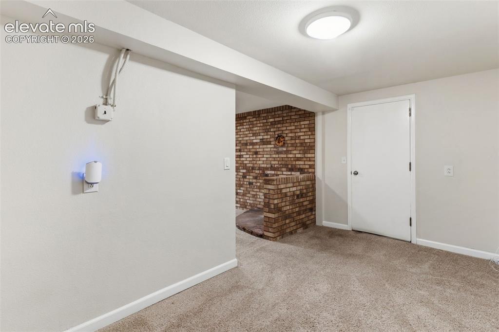 Image 16 of 27: Basement with access to mud room and garage