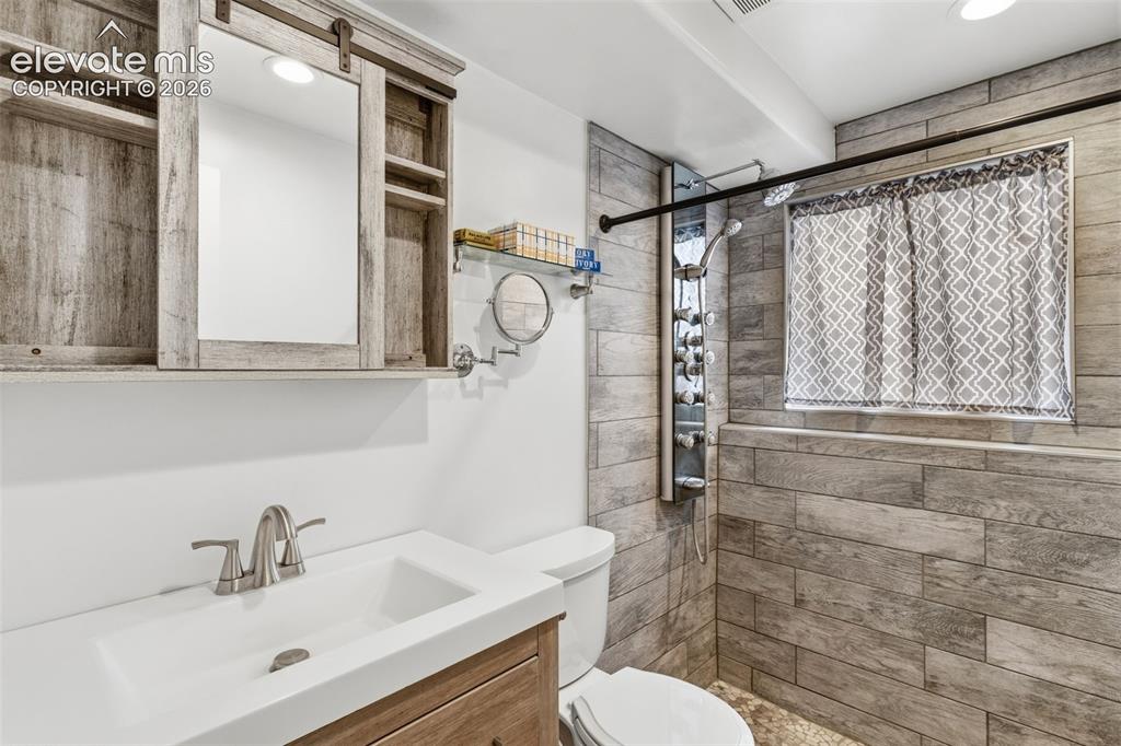 Image 19 of 27: Lower bathroom - updated with spa shower