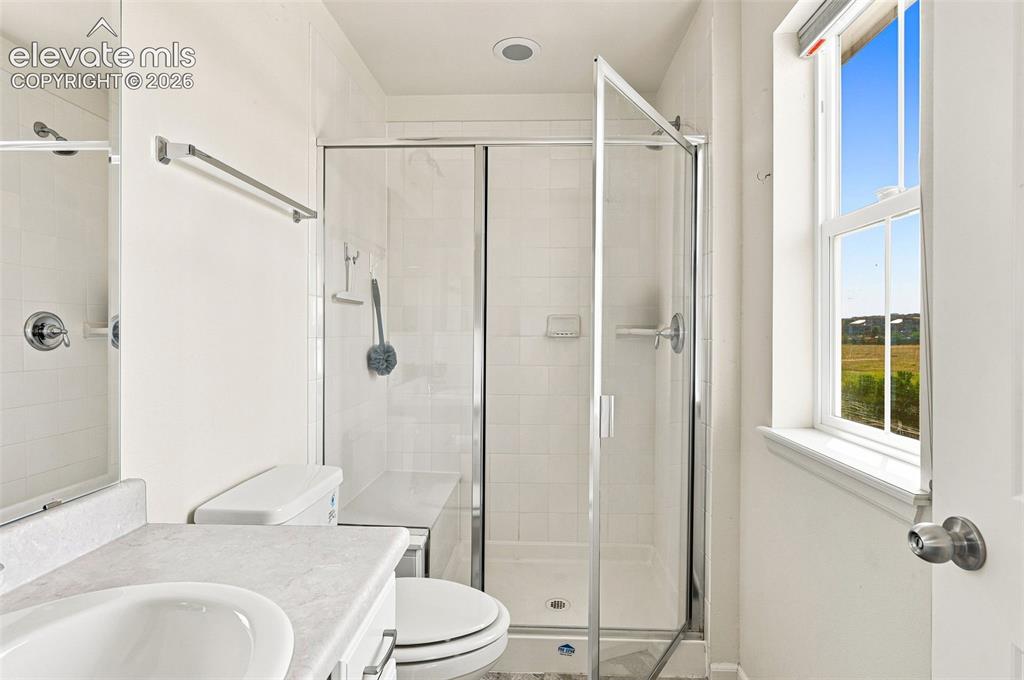 Image 19 of 39: En suite to primary bedroom with large shower and tile floor
