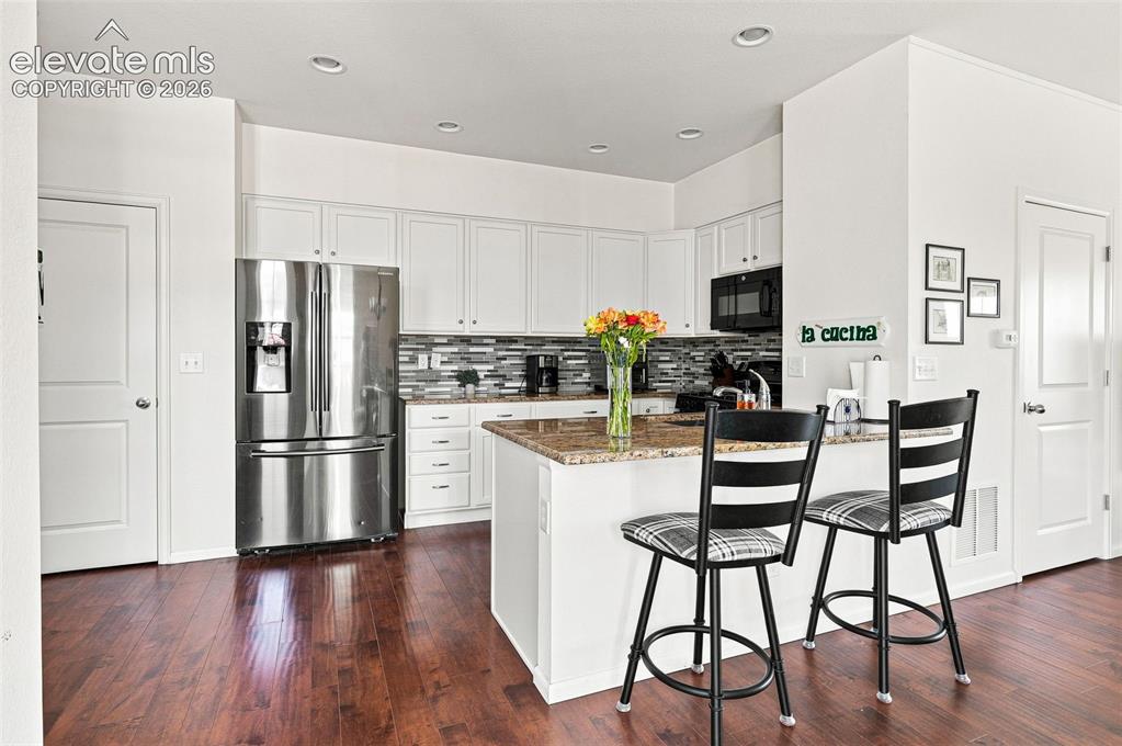Image 8 of 39: Light and bright adjacent to patio with granite countertops, counter with b