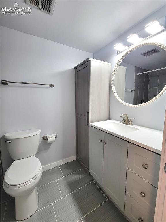 Image 12 of 31: Modern Primary Bathroom featuring a white vanity with integrated sink, brus
