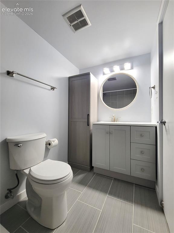 Image 14 of 31: Primary Bathroom featuring light gray wall paint, a white toilet, and gray