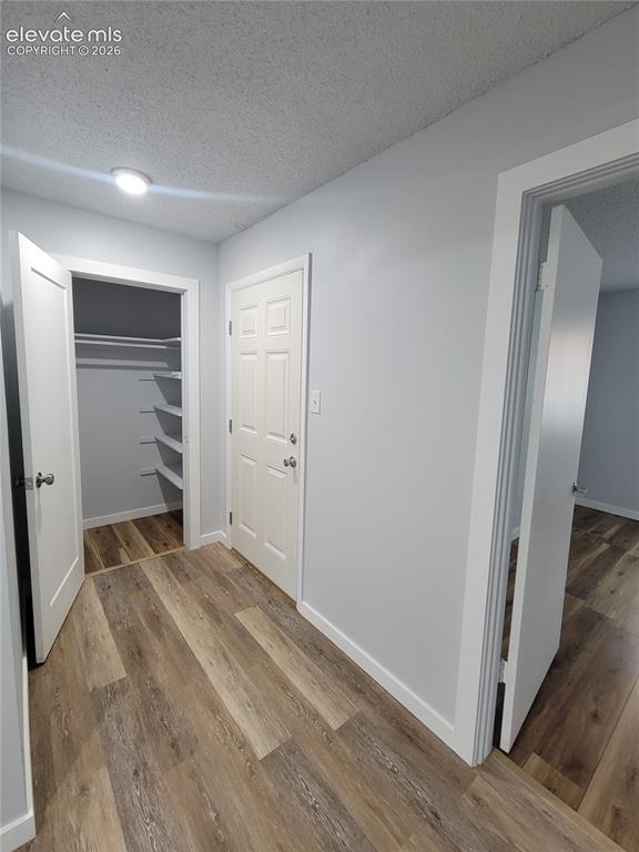 Image 16 of 31: Entryway featuring wood-finish flooring, light gray wall paint, and white t
