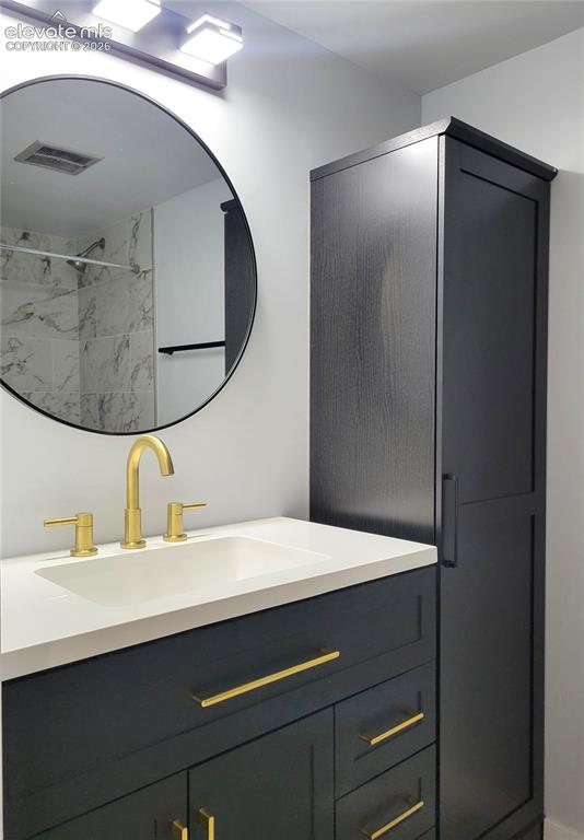 Image 18 of 31: Modern bathroom vanity with matte black cabinetry, a white countertop, and