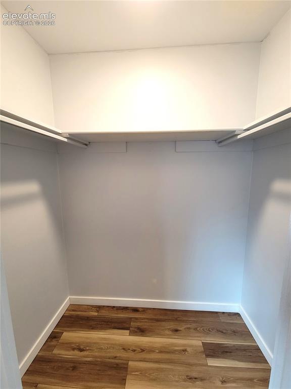 Image 22 of 31: Interior closet space featuring wood-finish flooring, white walls, and buil